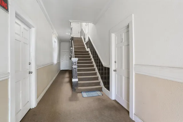 a view of backyard with wooden fence and trees