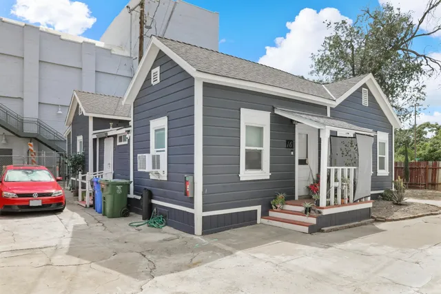 a view of staircase with wooden floor and white walls