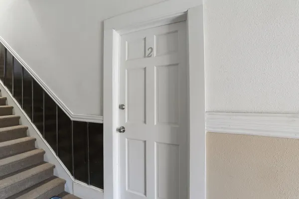 a view of hallway with closet and wooden floor