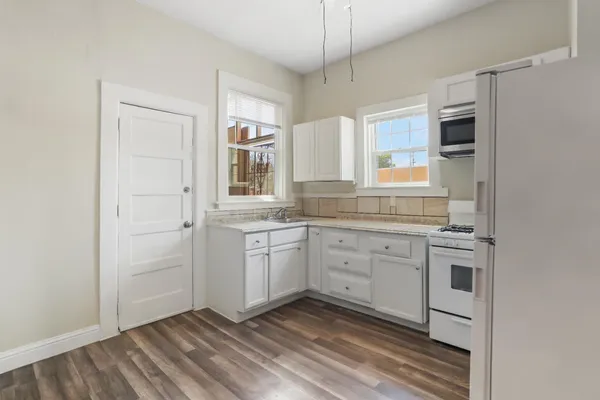a kitchen with a refrigerator stove and sink