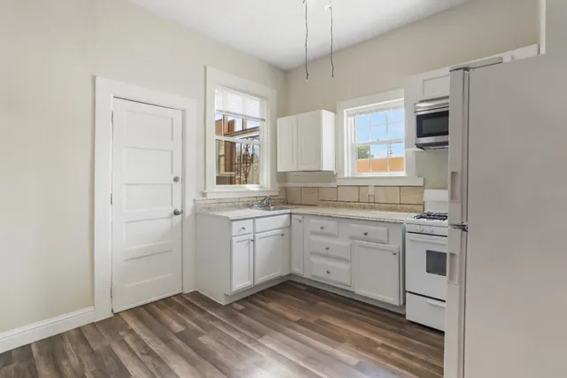 a kitchen with a refrigerator stove and sink