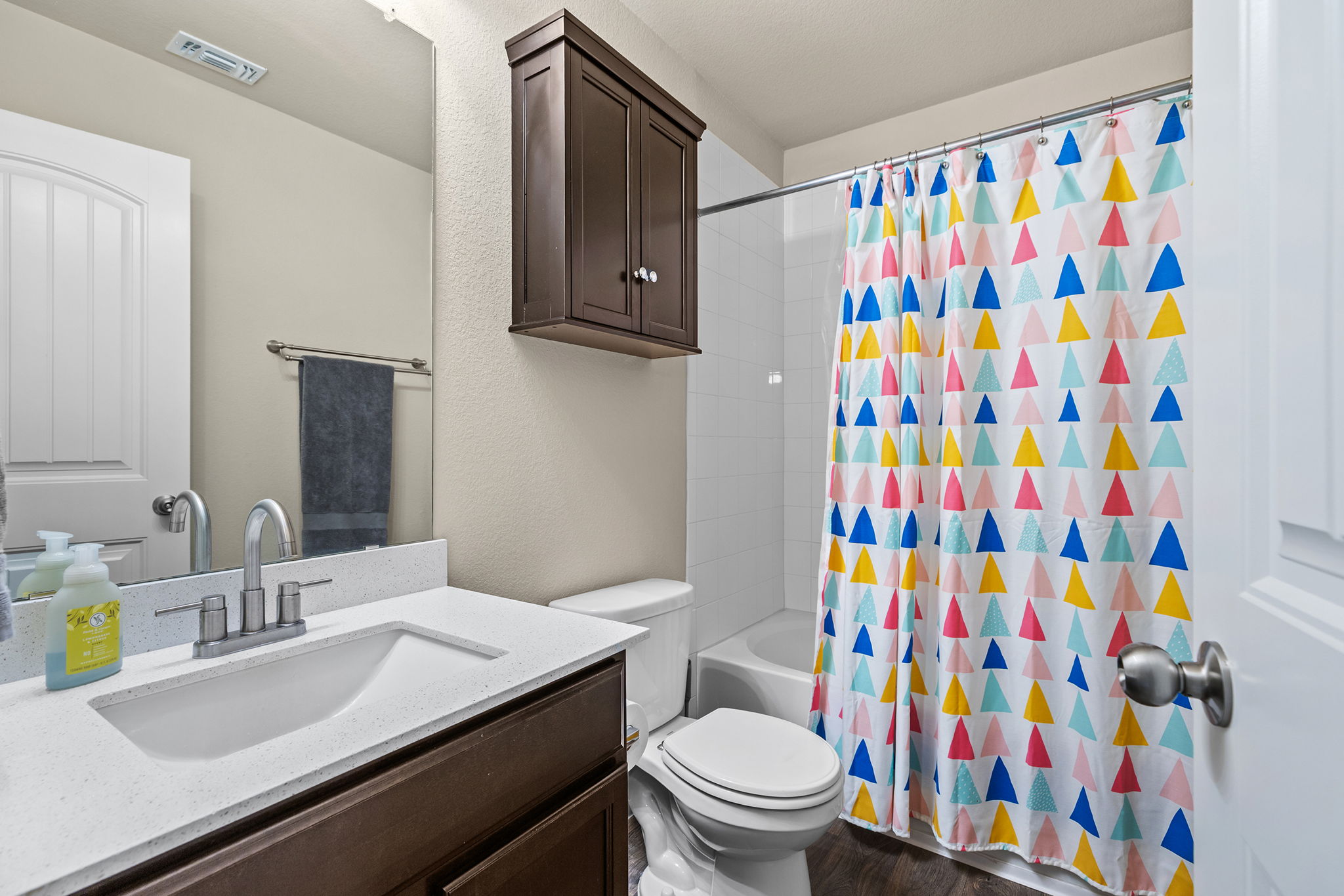 404 Cassandra Drive Hutto, TX 78634 - Photo 23 of 40 Full bathroom with vanity, shower / bathtub combination with curtain, and dark wood-type flooring