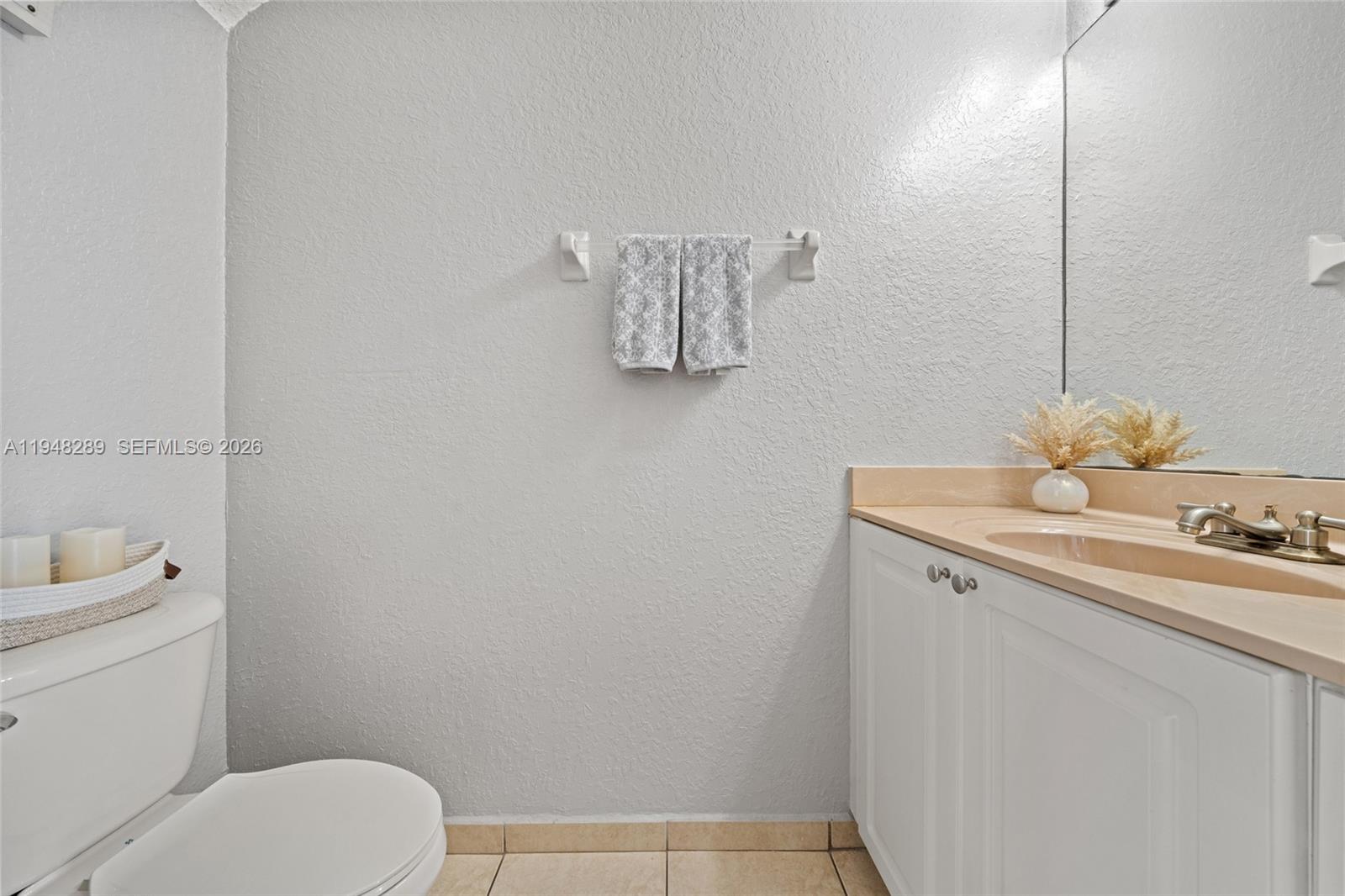 13770 Southwest 170th Lane Miami, FL 33177 - Photo 13 of 24 a bathroom with a toilet sink and mirror