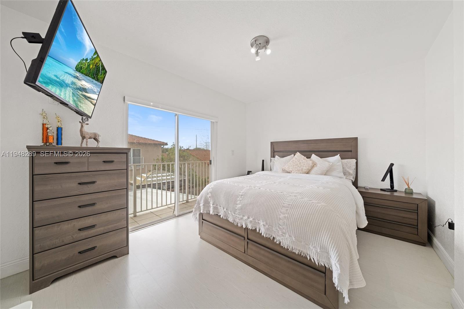 13770 Southwest 170th Lane Miami, FL 33177 - Photo 15 of 24 a bedroom with a bed and a flat screen tv