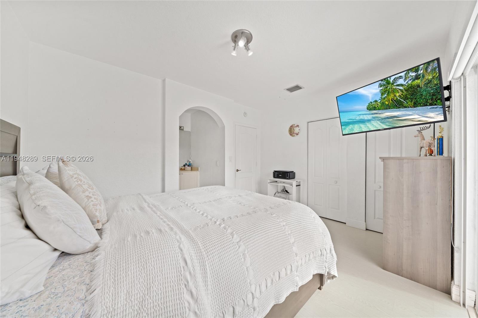 13770 Southwest 170th Lane Miami, FL 33177 - Photo 17 of 24 a spacious bedroom with a bed and a window