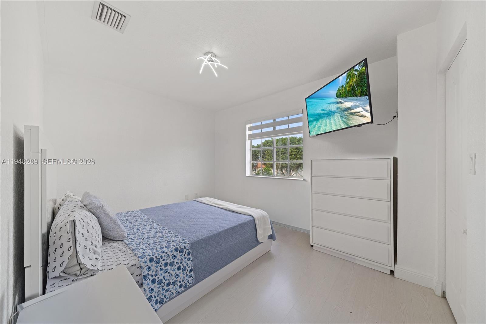 13770 Southwest 170th Lane Miami, FL 33177 - Photo 21 of 24 a bedroom with a bed and a window