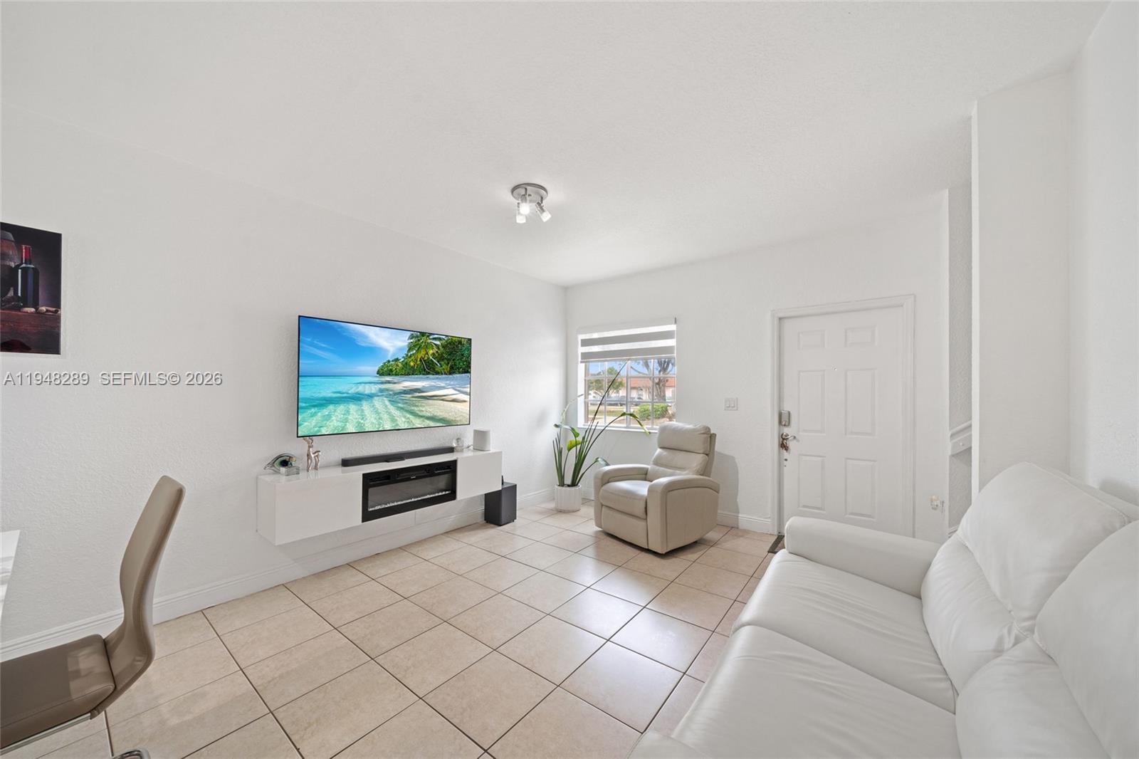 13770 Southwest 170th Lane Miami, FL 33177 - Photo 4 of 24 a living room with furniture and a flat screen tv