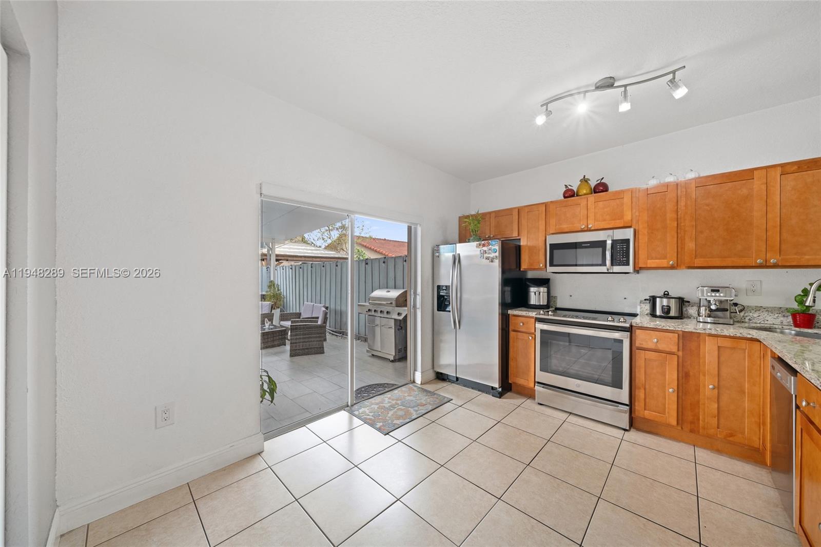 13770 Southwest 170th Lane Miami, FL 33177 - Photo 7 of 24 a kitchen with stainless steel appliances granite countertop a refrigerator and a sink