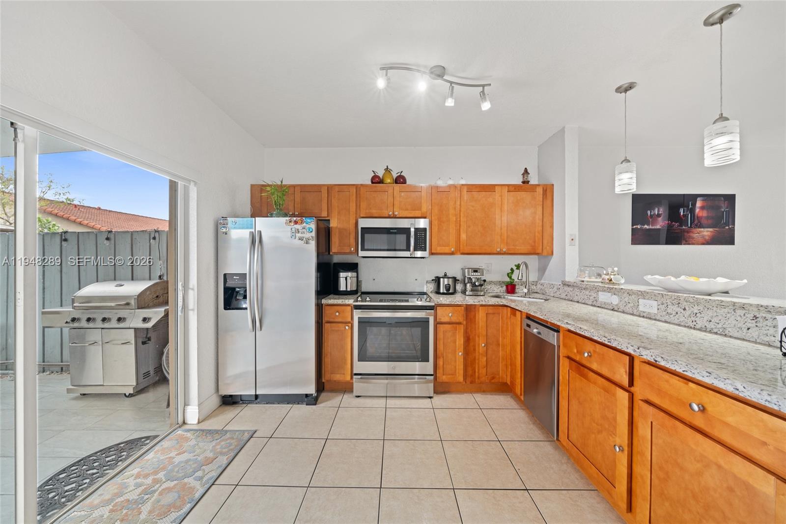13770 Southwest 170th Lane Miami, FL 33177 - Photo 8 of 24 a large kitchen with stainless steel appliances granite countertop a refrigerator and a sink