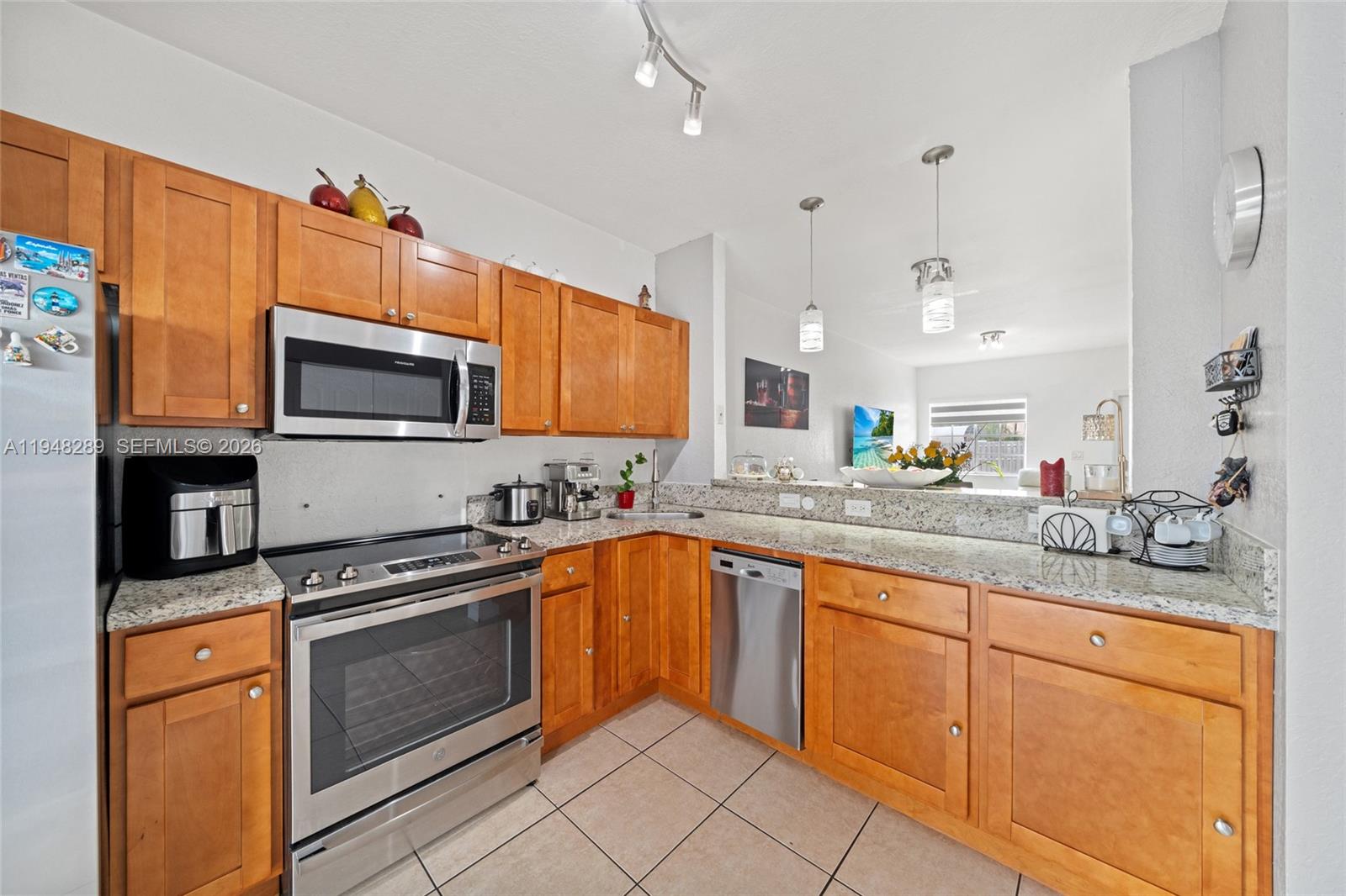 13770 Southwest 170th Lane Miami, FL 33177 - Photo 10 of 24 a kitchen with stainless steel appliances granite countertop a stove top oven a sink dishwasher and a microwave oven on the blue kitchen countertops