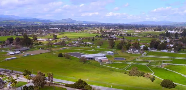 an aerial view of a golf course with chairs