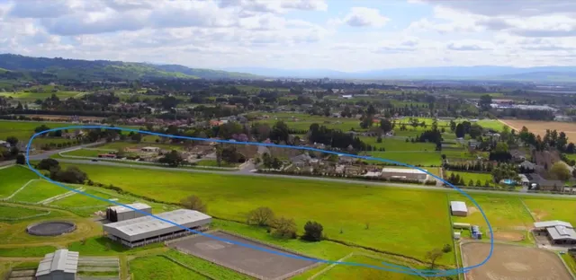 an aerial view of a house with a garden lake view