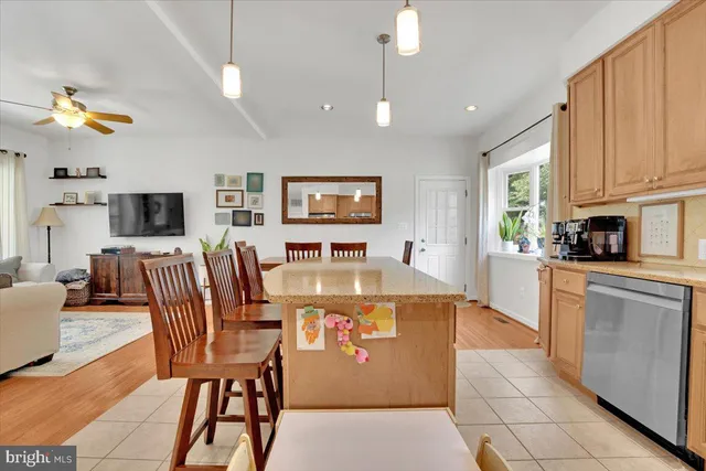 a view of kitchen with stainless steel appliances granite countertop cabinets table and chairs
