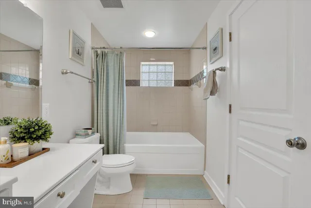 a bathroom with a white toilet sitting next to a bathroom sink