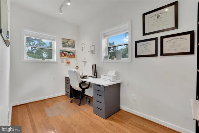 a view of a workspace with painting on the wall