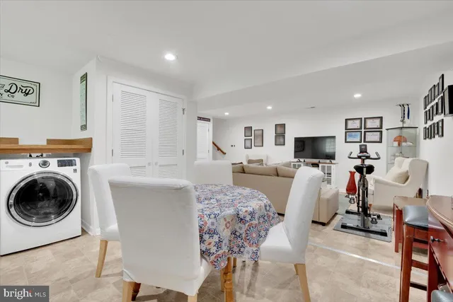 a living room with furniture and a view of kitchen