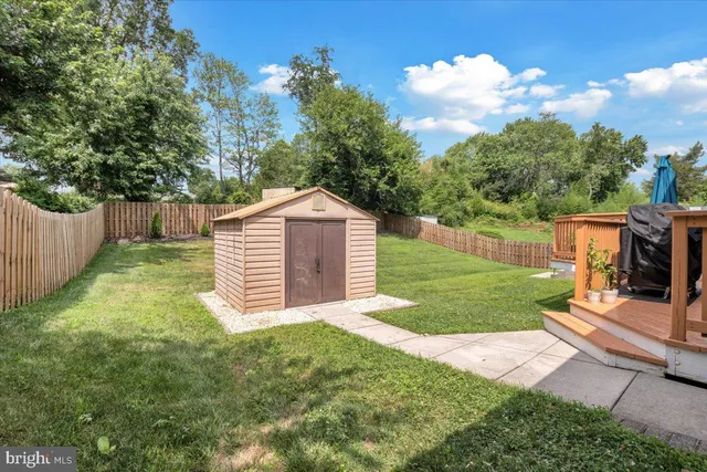 a view of house with backyard and outdoor seating