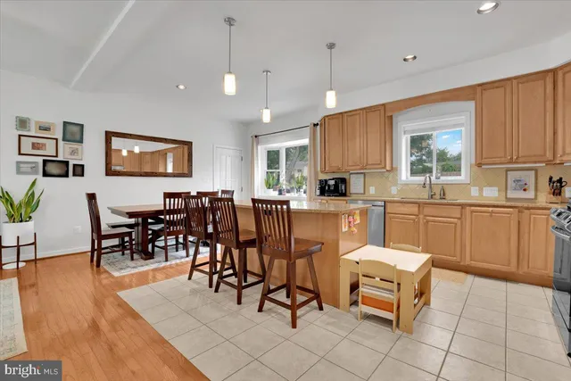 a kitchen with a dining table chairs and white cabinets