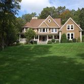 a front view of a house with a yard table and chairs