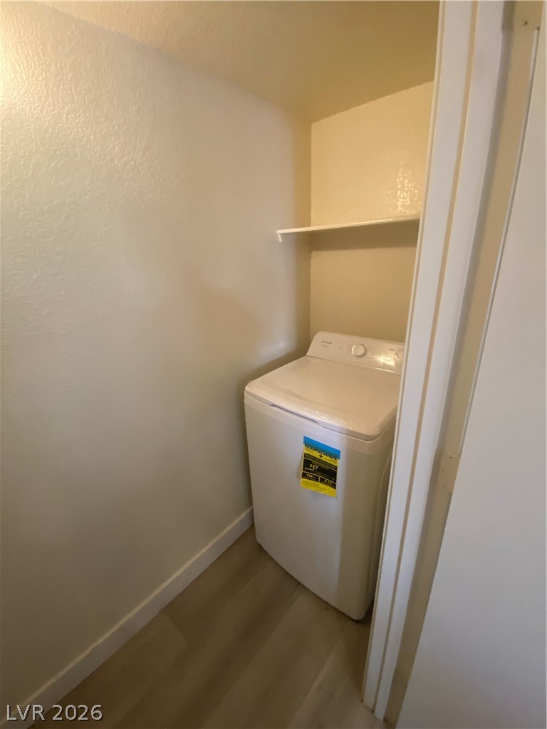 7570 West Flamingo Road, Unit 125 Las Vegas, NV 89147 - Photo 10 of 29 Laundry area featuring washer / clothes dryer and wood finished floors
