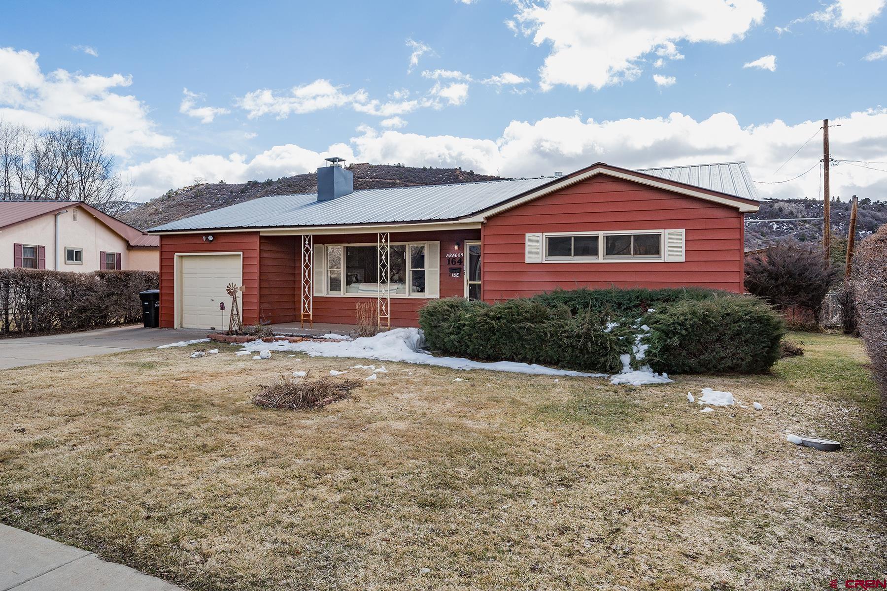 164 Riverview Drive Durango, CO 81301 - Photo 1 of 32 a front view of a house with a yard