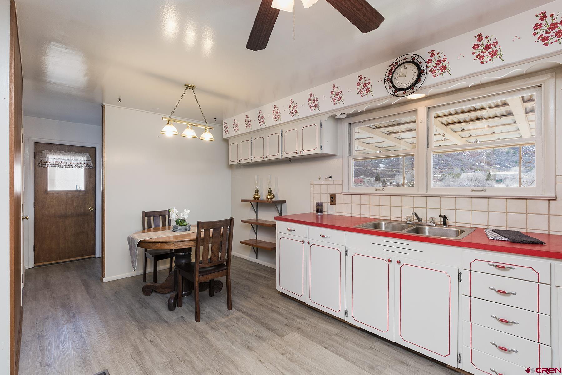 164 Riverview Drive Durango, CO 81301 - Photo 11 of 32 a kitchen with a white cabinets and window