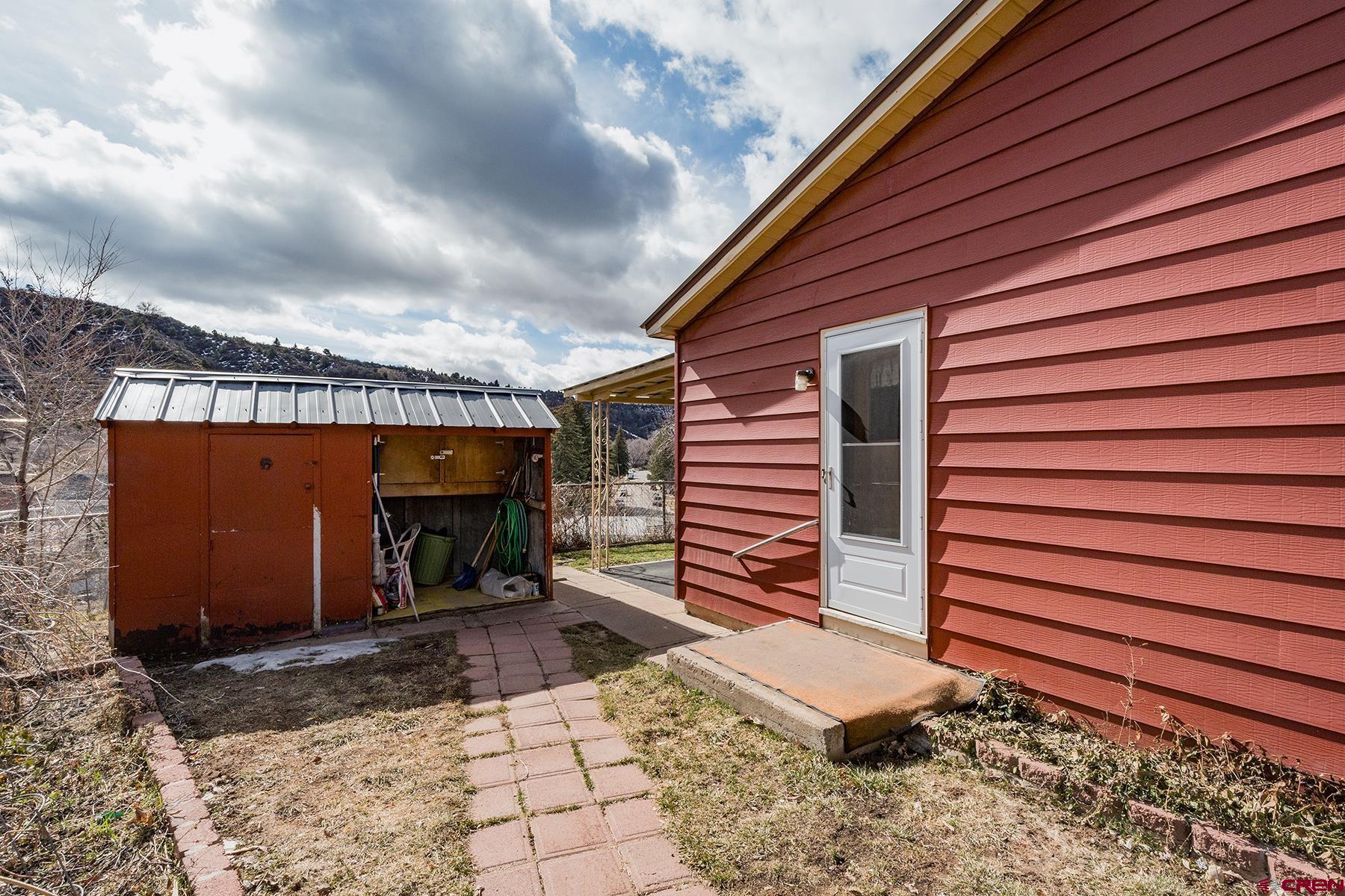 164 Riverview Drive Durango, CO 81301 - Photo 25 of 32 a front view of a house with garden