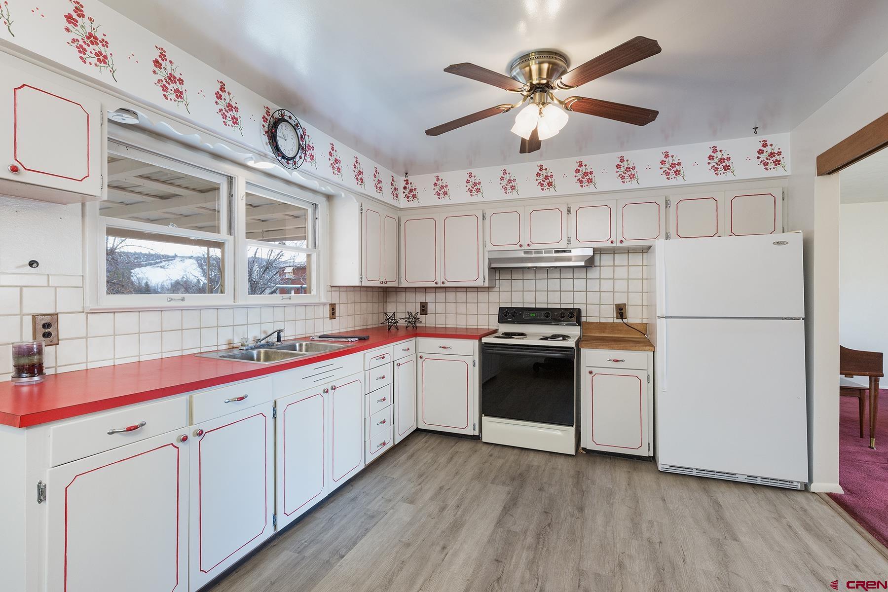 164 Riverview Drive Durango, CO 81301 - Photo 10 of 32 a kitchen with cabinets a sink and white appliances