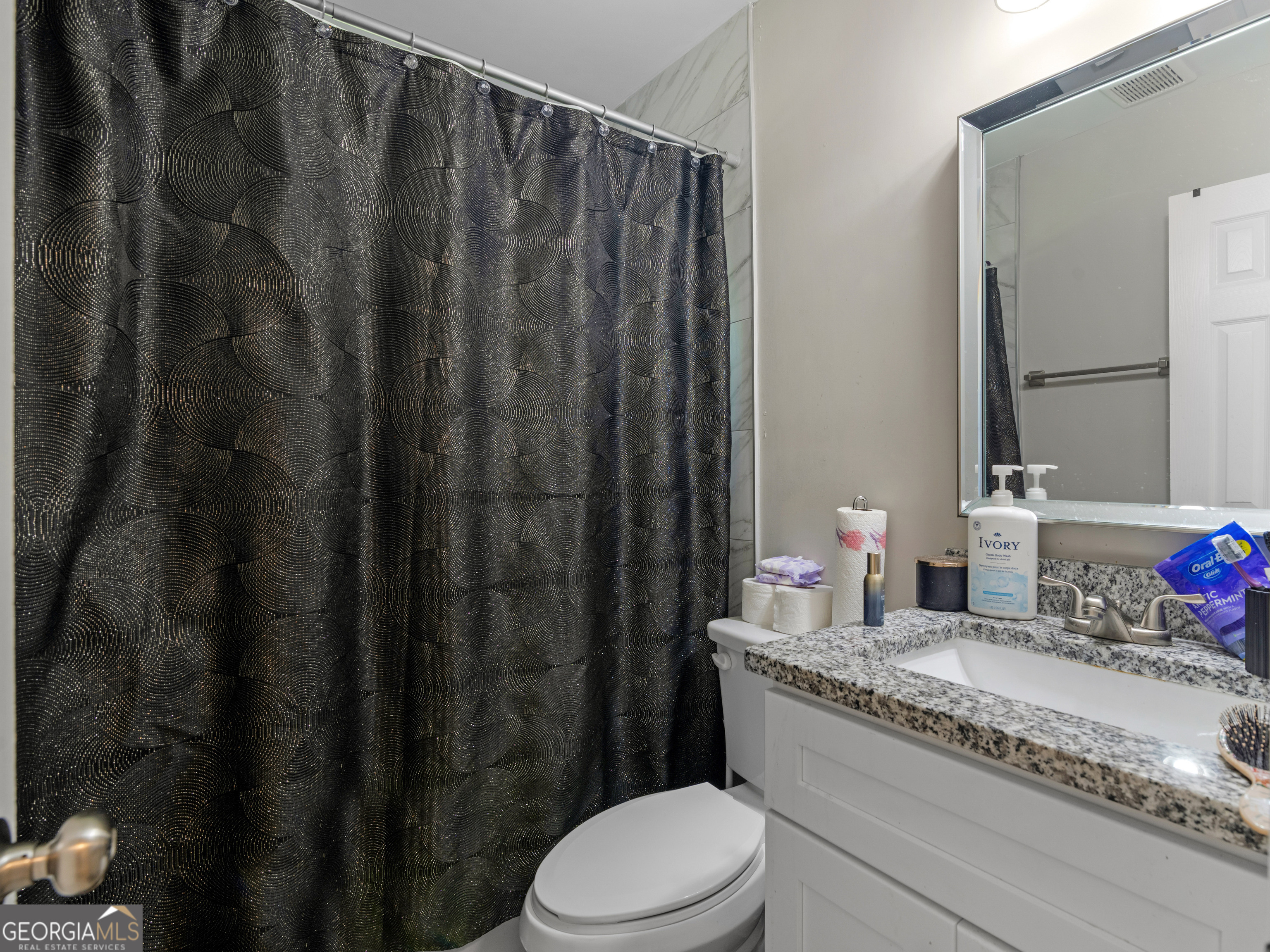 3445 Travis Boulevard Macon, GA 31206 - Photo 13 of 20 a bathroom with a granite countertop sink vanity mirror and toilet