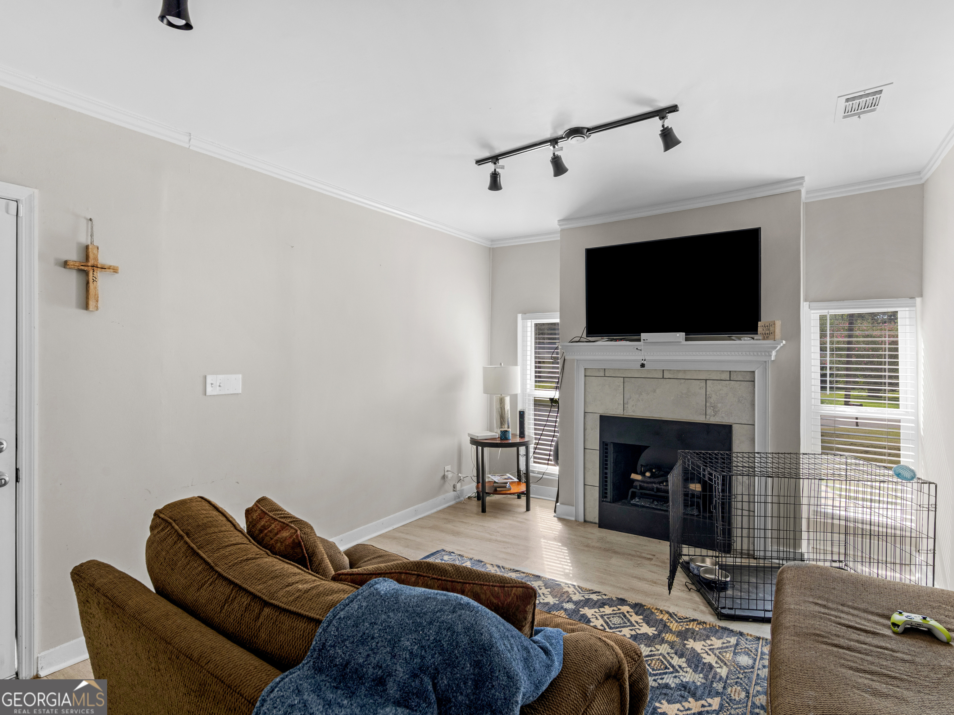 3445 Travis Boulevard Macon, GA 31206 - Photo 4 of 20 a living room with furniture a flat screen tv and a fireplace
