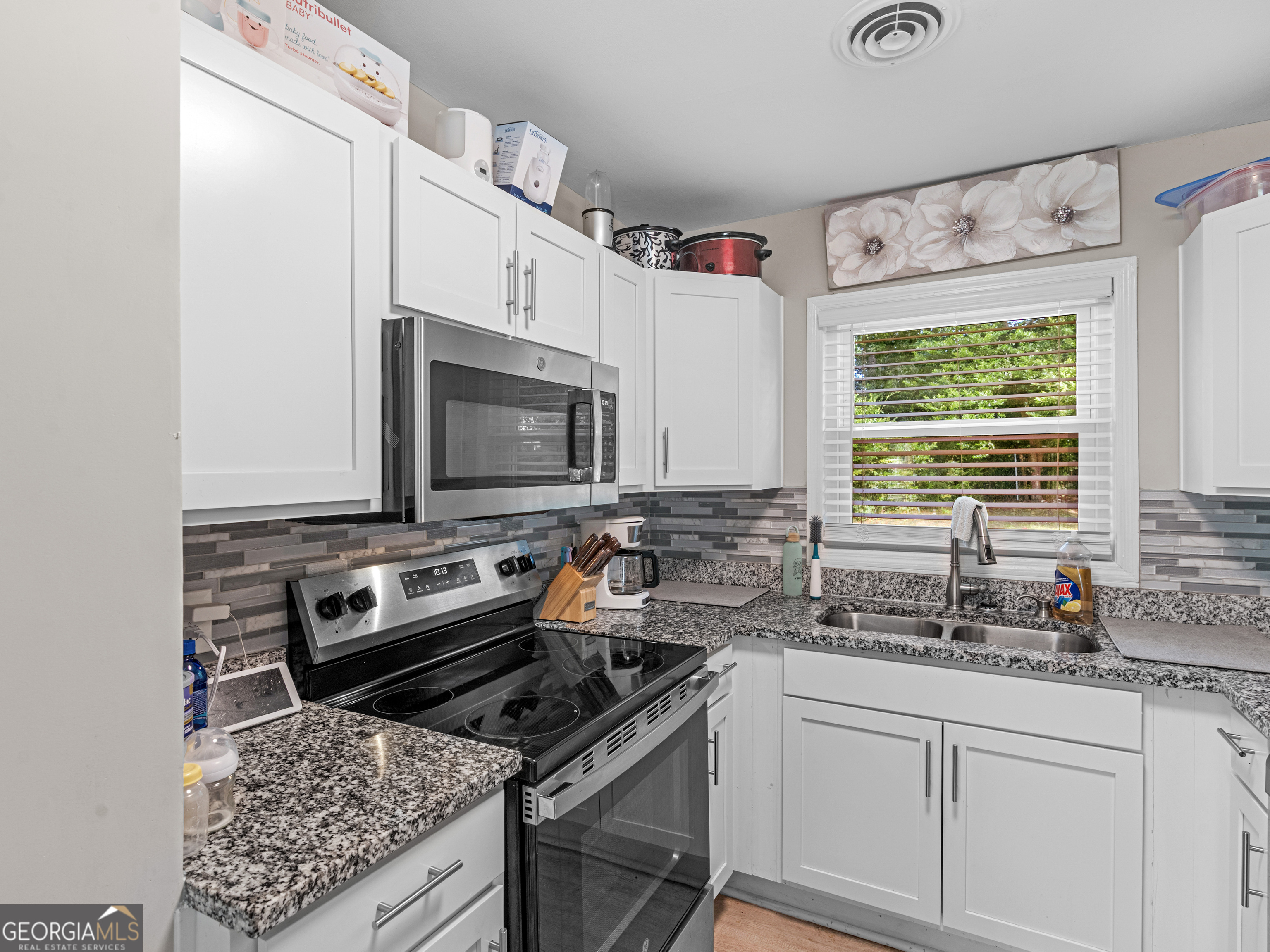 3445 Travis Boulevard Macon, GA 31206 - Photo 5 of 20 a kitchen with a stove a sink and a microwave