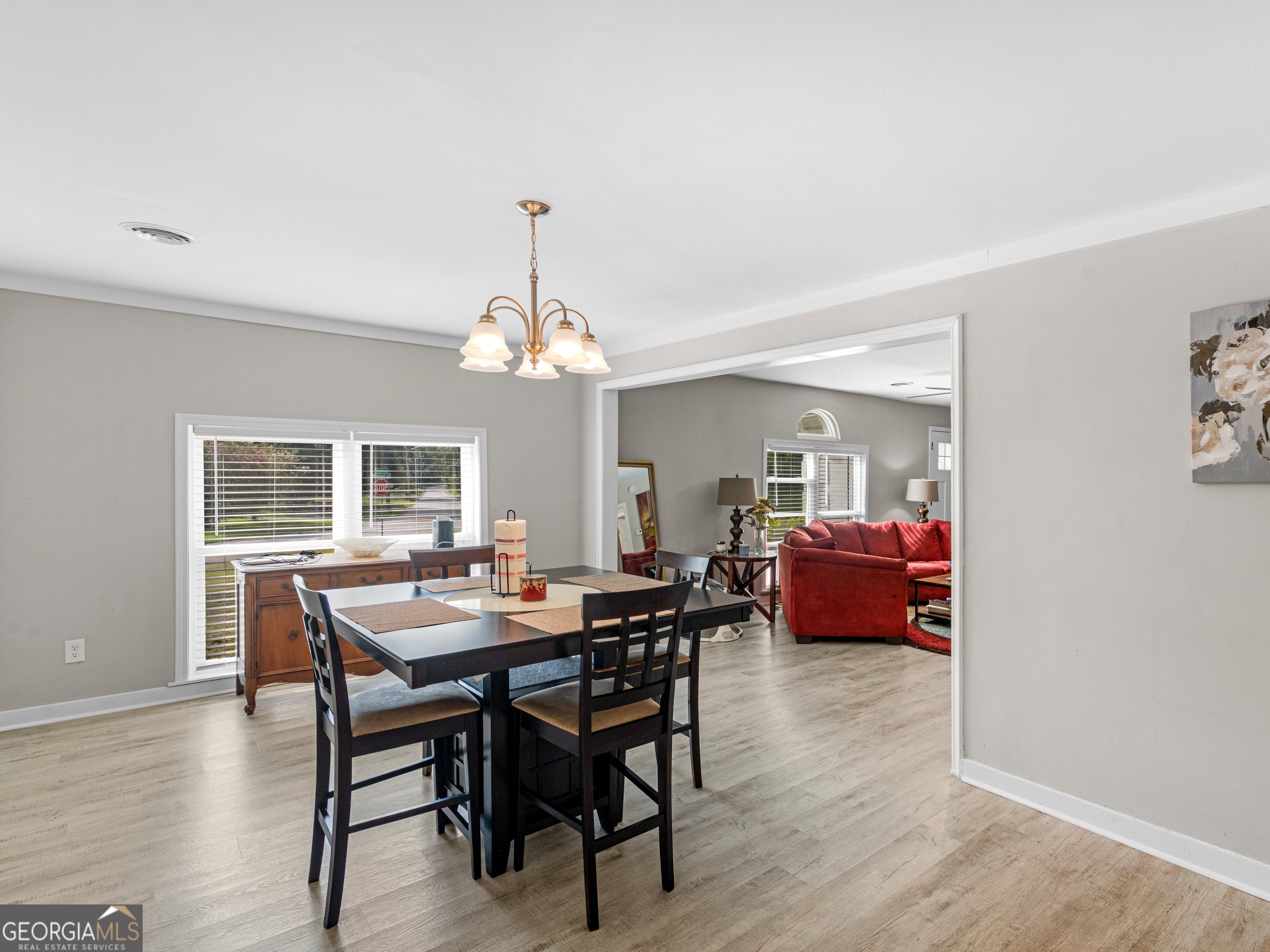 3445 Travis Boulevard Macon, GA 31206 - Photo 9 of 20 a view of a dining room with furniture a chandelier and wooden floor