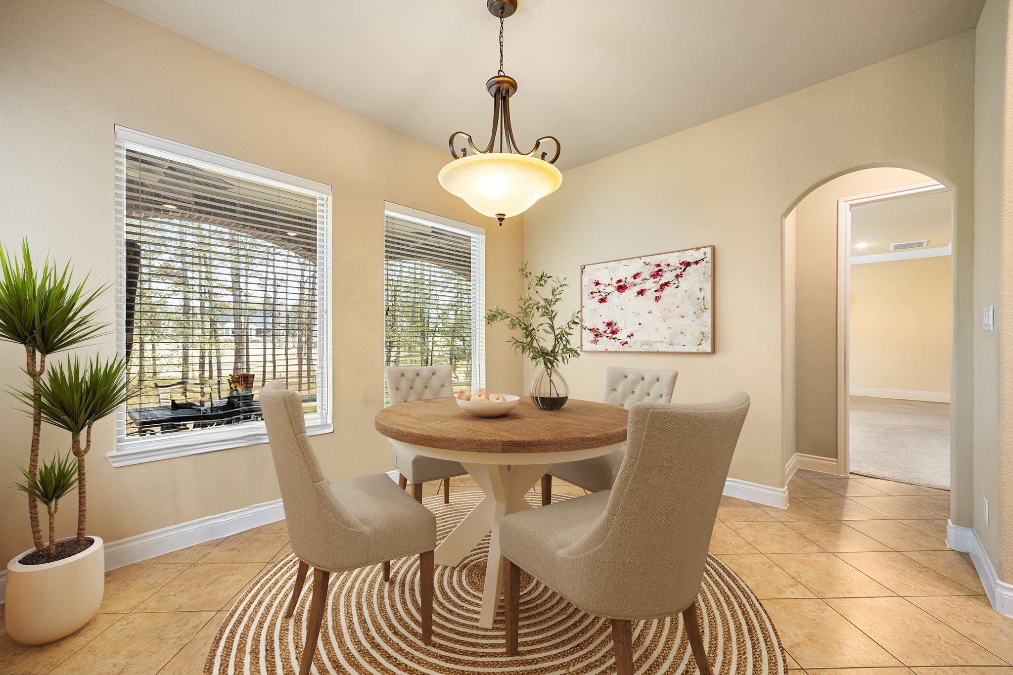23421 Cannondale Loop Montgomery, TX 77316 - Photo 11 of 47 Warm and inviting dining area featuring large windows that fill the space with natural light, tile flooring, and a stylish chandelier that creates a cozy ambiance. Perfectly sized for intimate meals or casual gatherings, this space flows effortlessly into the surrounding living areas, making everyday dining both comfortable and elegant.