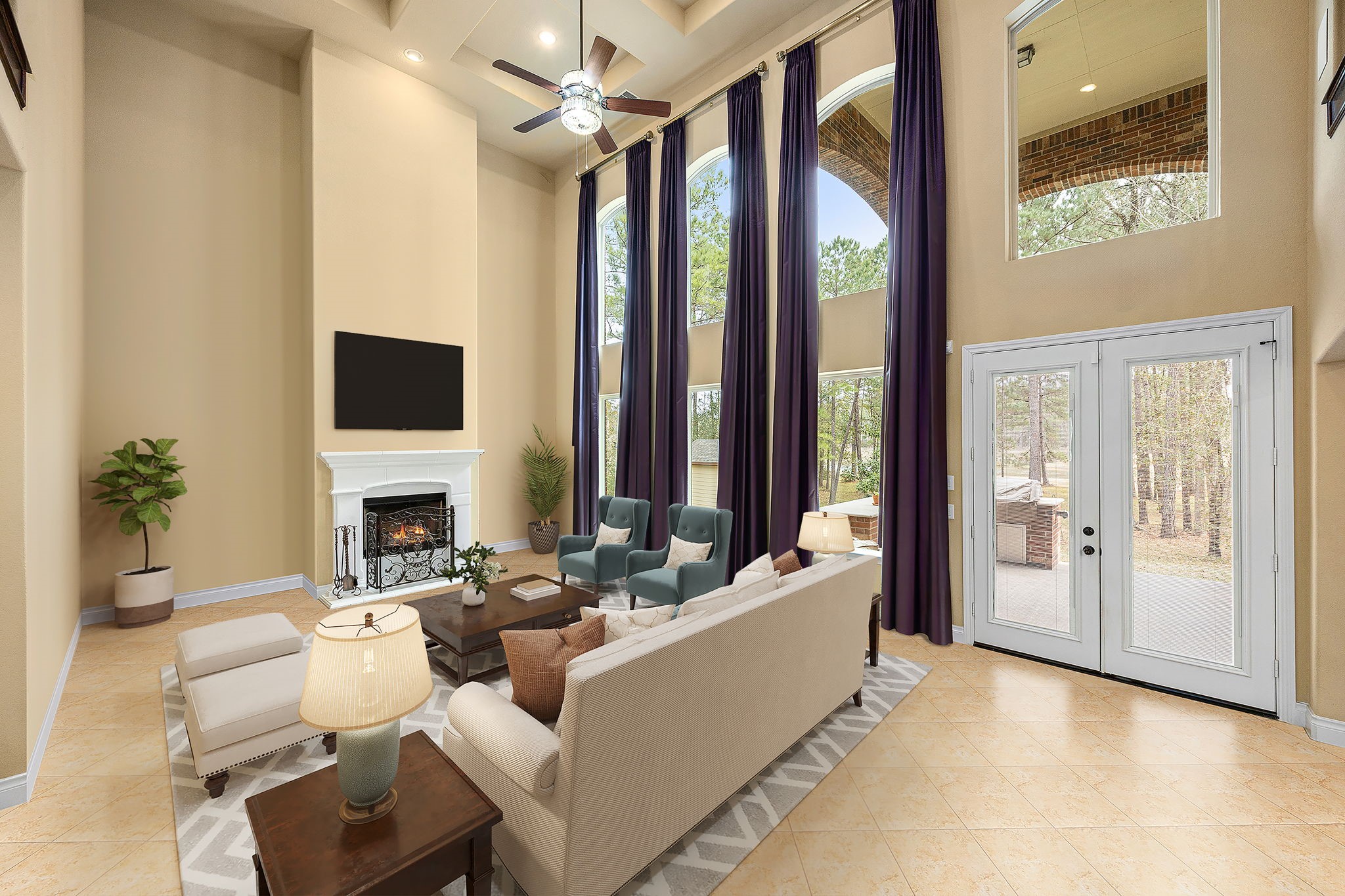 23421 Cannondale Loop Montgomery, TX 77316 - Photo 13 of 47 Stunning two-story living room showcasing soaring ceilings, elegant arched windows, and dramatic floor-to-ceiling drapery that bathe the space in natural light. Anchored by a beautiful fireplace and seamlessly connected to the outdoor living area, this open-concept space offers the perfect blend of comfort, style, and everyday luxury.