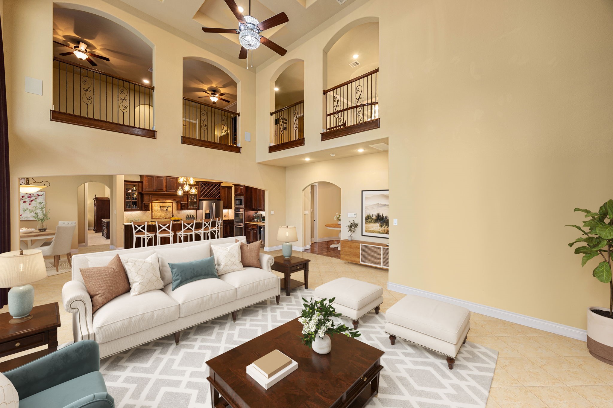 23421 Cannondale Loop Montgomery, TX 77316 - Photo 14 of 47 Grand open-concept living area with soaring ceilings, elegant arched openings, and wrought-iron balcony details overlooking the space. Seamlessly connected to the gourmet kitchen and perfect for both everyday living and entertaining, this impressive profiling showcases timeless architectural charm and exceptional flow throughout the home.