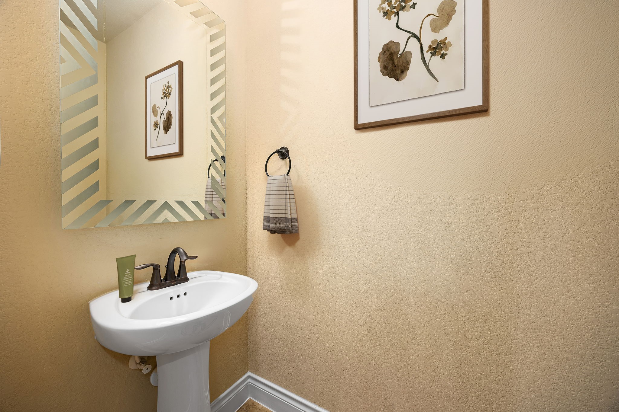 23421 Cannondale Loop Montgomery, TX 77316 - Photo 27 of 47 Powder bath off of the gameroom with a sleek pedestal sink, decorative framed mirror, and stylish dark hardware. Soft neutral walls, tasteful artwork, and thoughtful accents create a warm and inviting space that’s perfect for guests and everyday convenience.