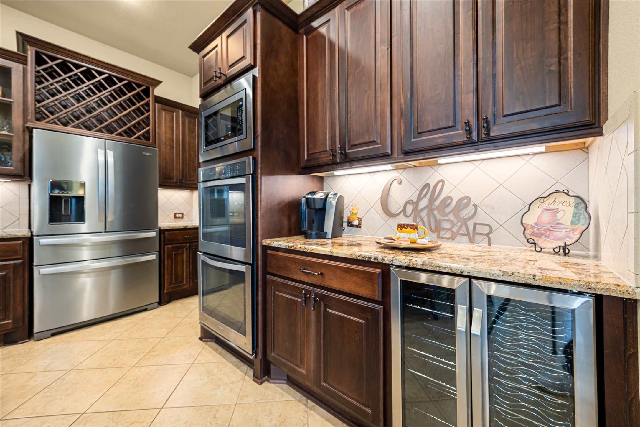 23421 Cannondale Loop Montgomery, TX 77316 - Photo 8 of 47 Enjoy the convience of a coffee/bar area with a dedicated double-door beveredge fridge under the countertop.