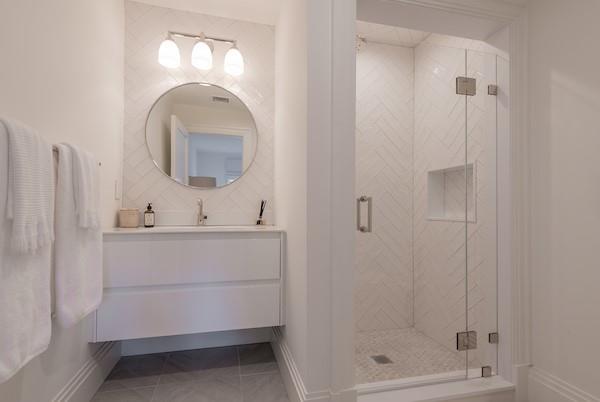 520 Hampton Road, Unit 18 Southampton, NY 11968 - Photo 12 of 20 a bathroom with a sink mirror and shower