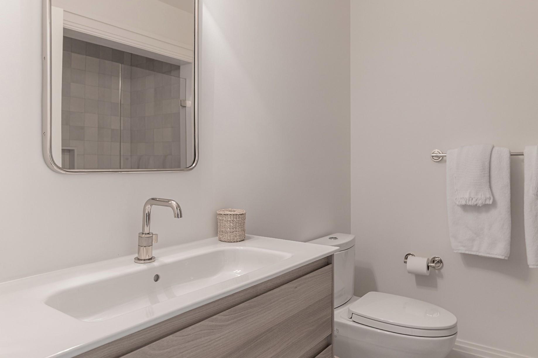 520 Hampton Road, Unit 18 Southampton, NY 11968 - Photo 14 of 20 a bathroom with a toilet sink and mirror