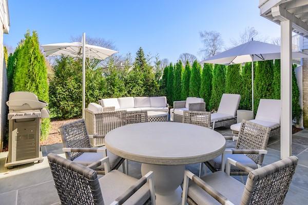 520 Hampton Road, Unit 18 Southampton, NY 11968 - Photo 16 of 20 a patio with a yard table and chairs