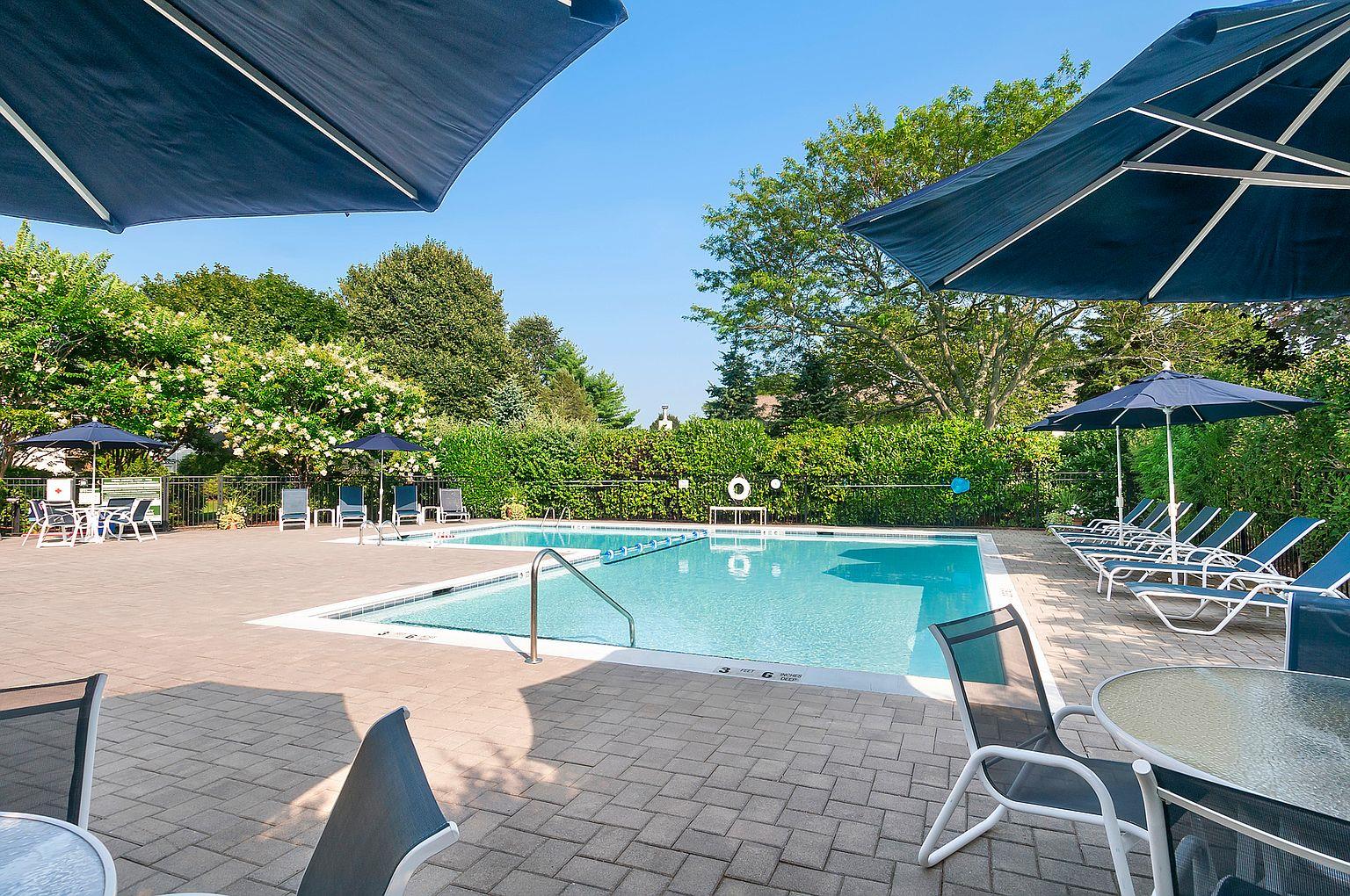520 Hampton Road, Unit 18 Southampton, NY 11968 - Photo 18 of 20 an outdoor space with swimming pool having patio