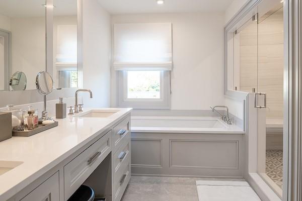 520 Hampton Road, Unit 18 Southampton, NY 11968 - Photo 10 of 20 a bathroom with a granite countertop sink a mirror and a bathtub