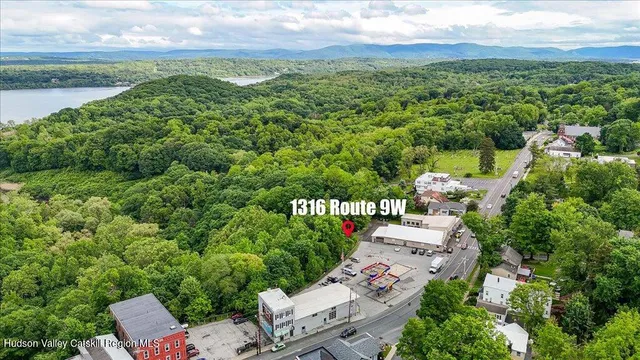 an aerial view of a house with garden space and outdoor seating