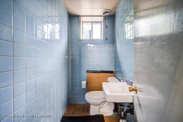 a kitchen with a refrigerator and a stove top oven
