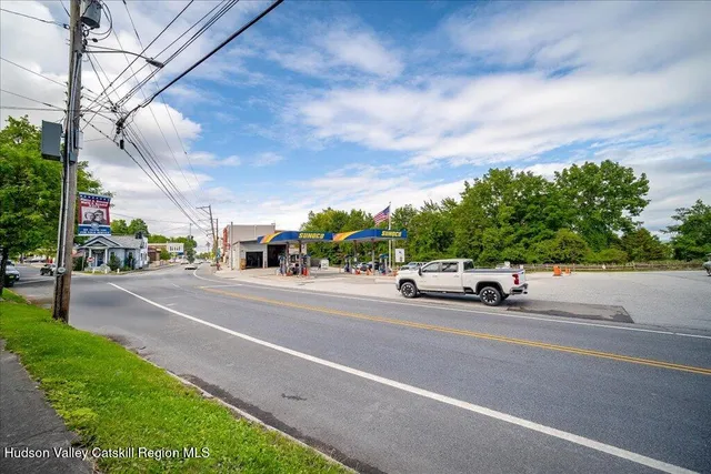 an aerial view of a house with a yard and lake view