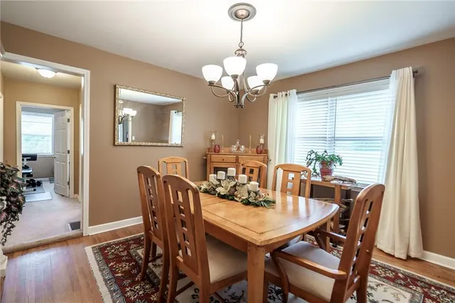 a view of a dining room with furniture wooden floor and a chandelier