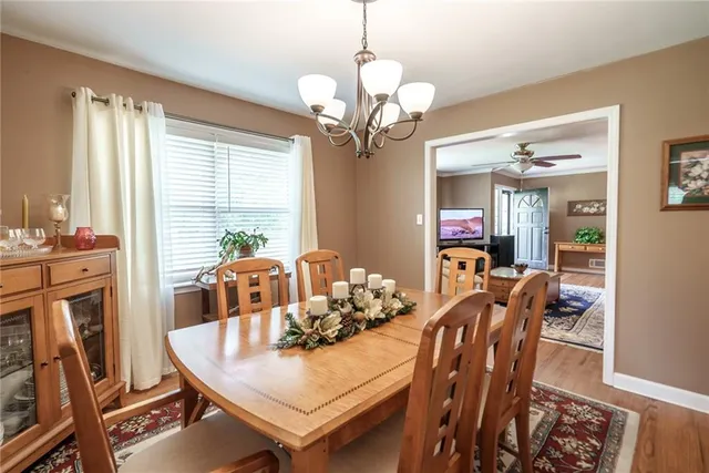 a living room with furniture a chandelier and a large window