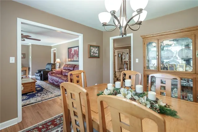 a kitchen with granite countertop white cabinets white appliances a sink and dishwasher