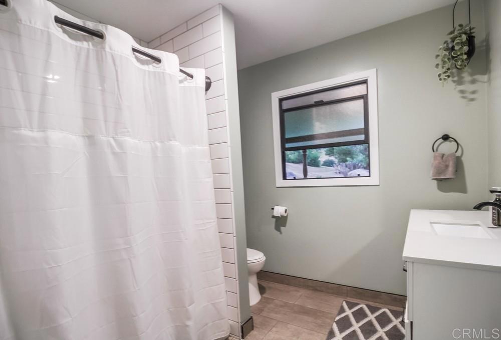 2444 Via Dieguenos Alpine, CA 91901 - Photo 32 of 69 a bathroom with a shower curtain and a sink