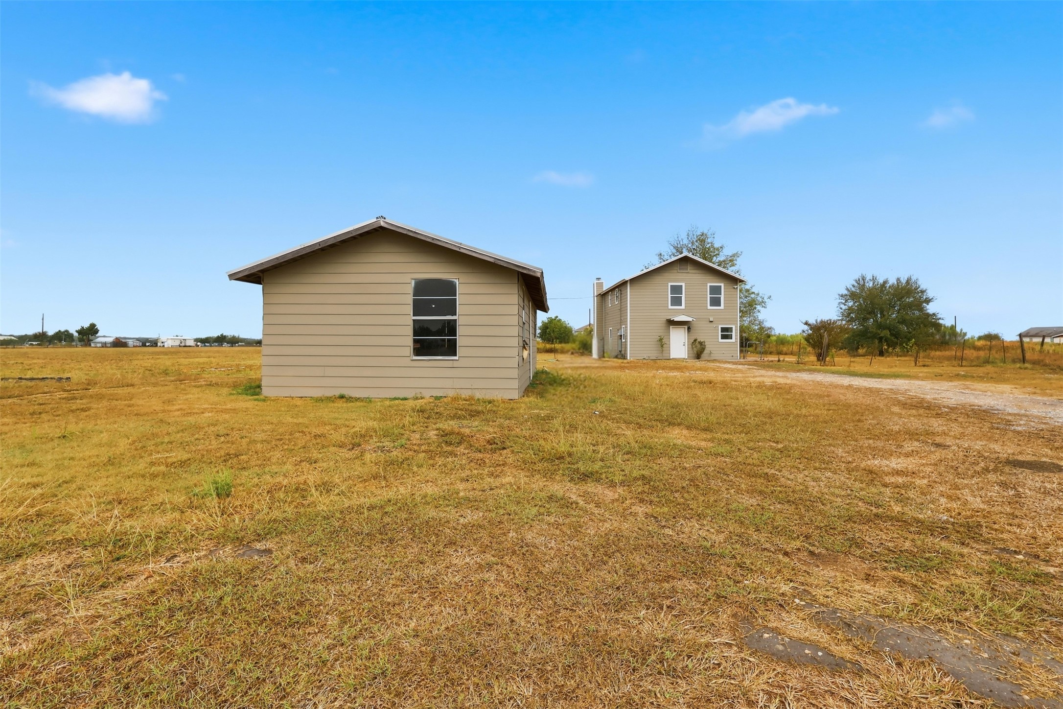 a house with yard and wooden fence